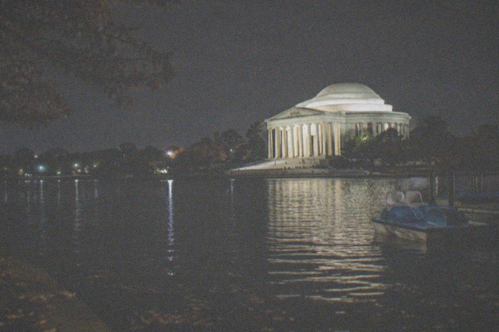 Jefferson Memorial glowing above the Tidal Basin with dark water in the foreground