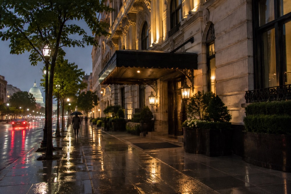A historic hotel facade illuminated at night in downtown Washington DC